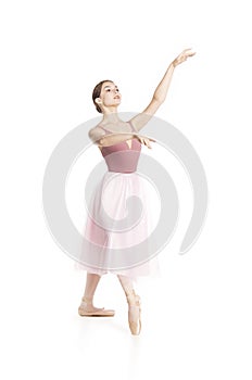 Elegant girl in a pink skirt and beige top dancing ballet