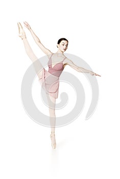 Elegant girl in a pink skirt and beige top dancing ballet