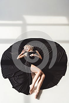 elegant girl posing in black dress photo