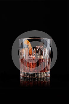elegant glass of Bourbon Old Fashioned, on black background