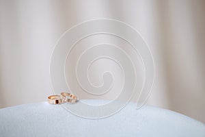 Elegant gold rings on a white fabric stand