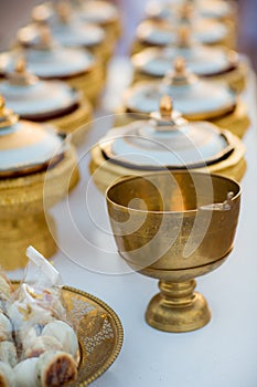 Elegant golden bowl for bride and groom give aims food to Buddhist monk photo