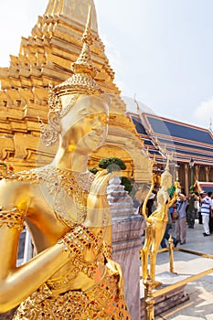Elegant golden Kinnari statue at Grand Palace
