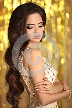 Elegant gorgeous brunette in beige evening dress. Fashion Glamour style. Beauty makeup and wavy hairstyle. Beautiful woman with l