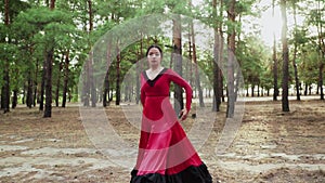 Elegant and graceful asian woman are dancing Traditional Spanish dance in summer forest