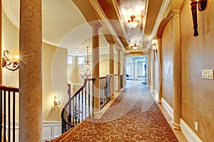 Elegant hallway with black railing.