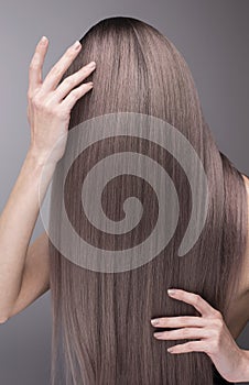 Elegant hands with nude manicure and perfect purple long hair.