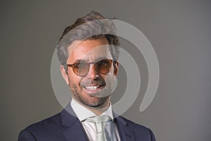 Elegant and handsome happy man in suit posing for company corporate business portrait relaxed and confident smiling happy