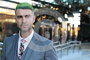 Elegant handsome man with green hair in office space