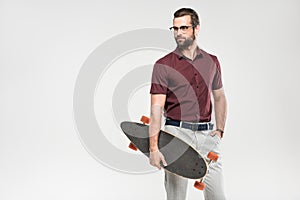 elegant handsome man posing with skateboard,