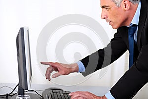 Elegant hipanic business man pointing the computer