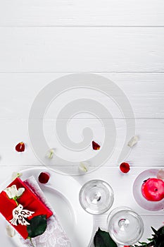 Elegant holiday table setting with red ribbon gift