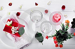 Elegant holiday table setting with red ribbon gift