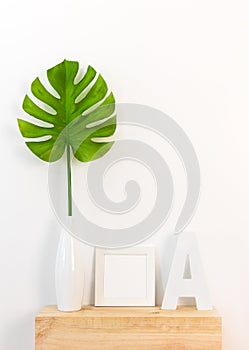 Elegant home decor with picture frame and tropical leaf