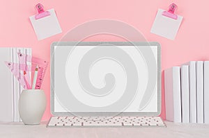 Elegant home workplace with stylish silver blank computer notebook and white stationery, stickers on pink background.