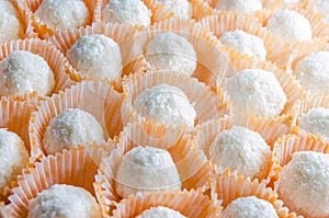 Elegant homemade white coconut candy in orange punnet