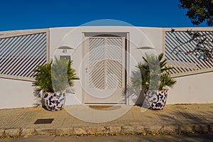 Elegant house entrance portico with natural wood double doors