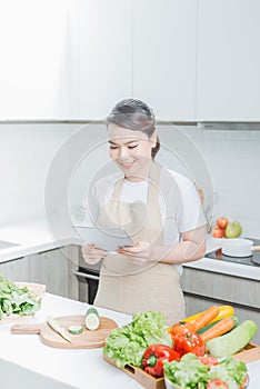 Elegant housewife found new recipe for cooking in kitchen