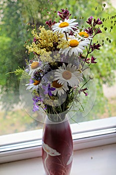 Elegant ikebana from wildflowers in a vase.