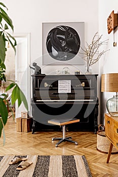Elegant interior of living room with black piano, furniture, plant, flower, wooden clock, lamp, mock up painitngs, decoration.