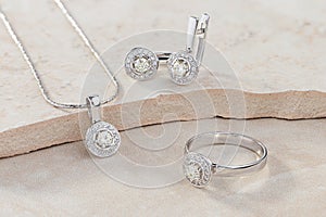 Elegant jewelry set of white gold ring, necklace and earrings with diamonds