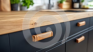 Elegant kitchen close-up featuring custom leather-wrapped cabinetry handles on matte black drawers under natural light photo