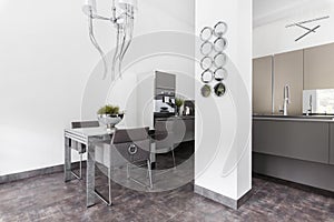 Elegant kitchen with dining room table and grey design in fashionable house