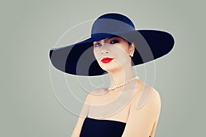 Elegant lady fashion model with red lips makeup, classic hat and white pearls