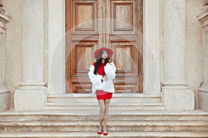 Elegant lady. Fashion woman in red hat and dress wearing in whit