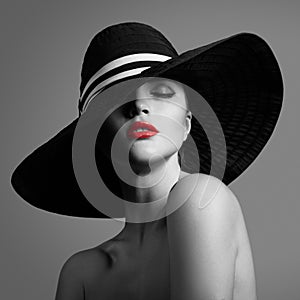 Elegant lady in hat. Black and white fashion portrait.