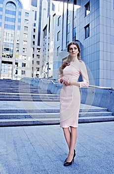 Elegant lady standing next to the office building