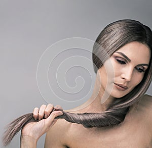 Elegant looking down woman with long and strong purple hair