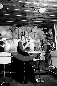 an elegant loving couple is in a restaurant. black and white photo