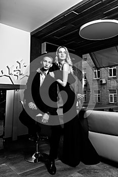 an elegant loving couple is in a restaurant. black and white photo