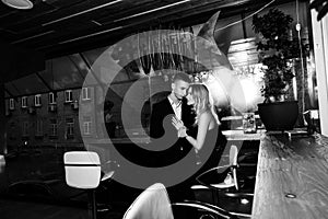 an elegant loving couple is in a restaurant. black and white photo