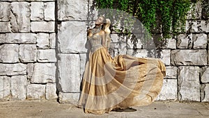 Elegant luxury evening fashion. Glamour, stylish elegant woman in long gown dress is posing outdoor in luxury resort in Turkey.