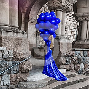 Elegant luxury fashion. Glamour, stylish elegant woman in long gown sequin dress is holding bunch of balloons. Female model in