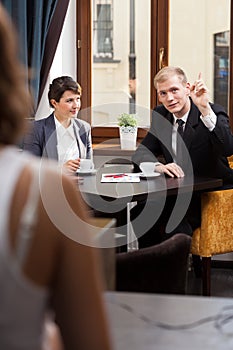 Elegant man asking for waitress