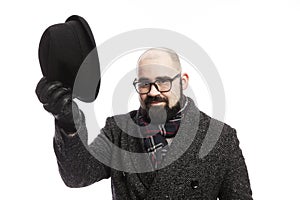 Elegant man with a beard in a coat. He took off his hat.  on a white background