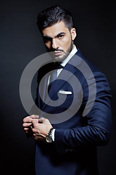 Elegant man with blue classic dress in studio pose