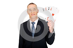 Elegant man with four aces