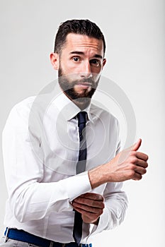 Elegant man hesitant while dressing up