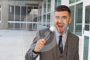 Elegant man holding microphone and talking