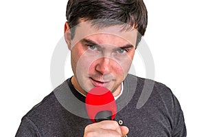 Elegant man with red microphone on white