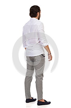 Elegant Man Standing Relaxed. Rear View