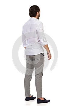 Elegant Man Standing Relaxed. Rear View photo