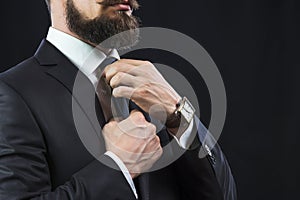 Elegant man tying up his tie