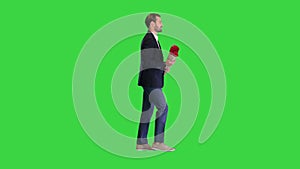 Elegant man walking with bouquet of red roses on a Green Screen, Chroma Key.