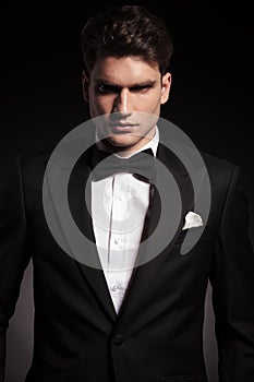 Elegant man wearing a black tux. photo