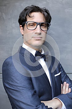 Elegant man wearing suit, bowtie and eyeglasses
